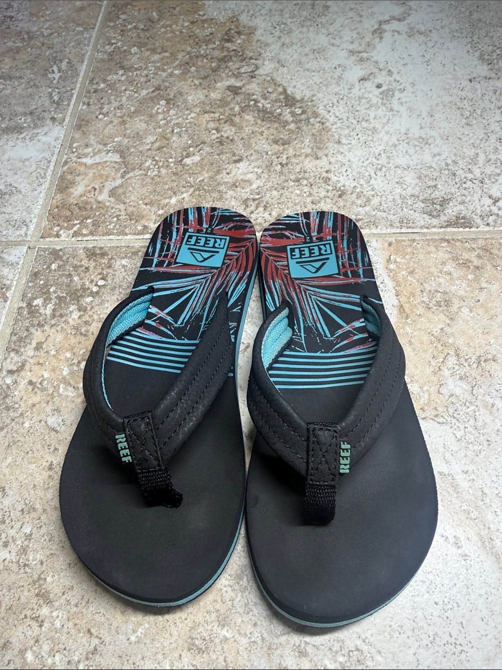 Size 2 youth, Reef Black Flip Flops with Teal/black. In great condition